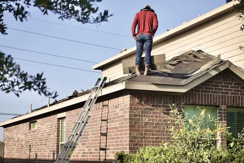 Professional roofer working on a residential roof in Yucca Corridor